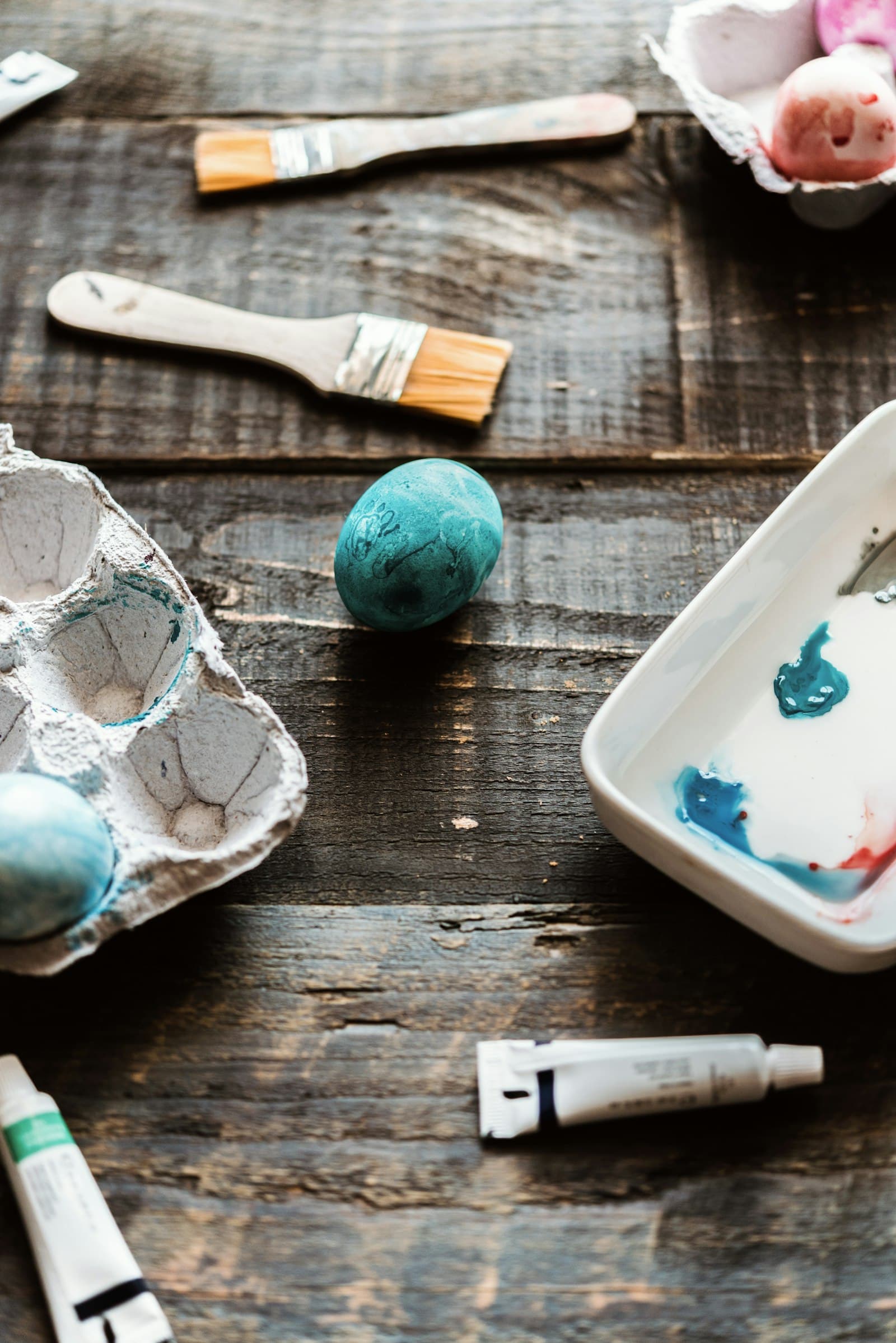 Wooden table set up with paint and craft supplies ready for kids